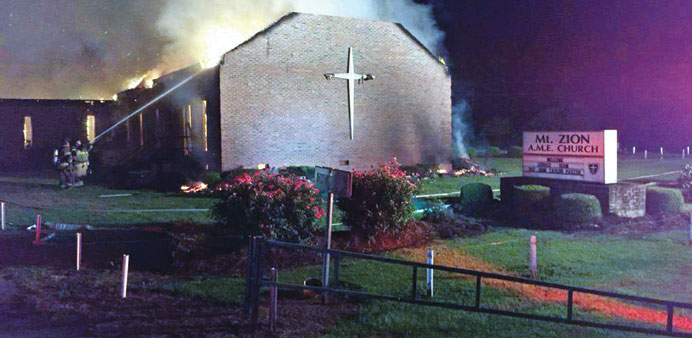 Fire crews try to control a blaze on Tuesday night at the Mt Zion African Methodist Episcopal Church in Greeleyville, South Carolina.