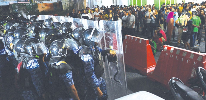 Riot police officers facing supporters of former Maldivian president and presidential candidate Mohamed Nasheed during a protest yesterday in Male.