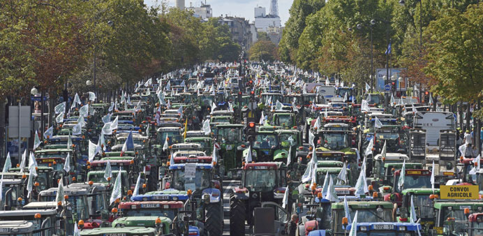 Farmers steer their tractors as part in a national demonstration on the Cours de Vincennes avenue near Place de la Nation in Paris, yesterday to prote