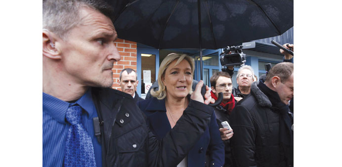 French far-right National Front leader Marine Le Pen leaves the polling station after casting her ballot in Henin-Beaumont.