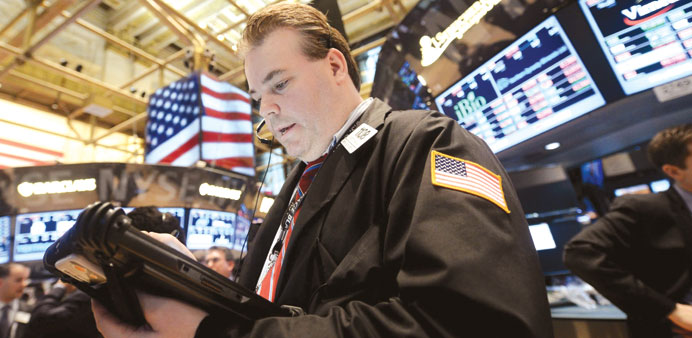 A trader works on the floor of the New York Stock Exchange at the Closing Bell yesterday. The Dow Jones industrial average is within 100 points of its