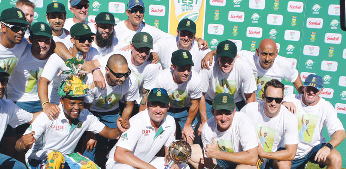 South African team poses with winneru2019s trophy after winning the second and final Test against India at Kingsmead, Durban, on Monday. (AFP)
