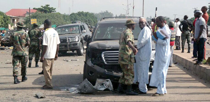 Military officers and citizens after the bomb attack in Kaduna.