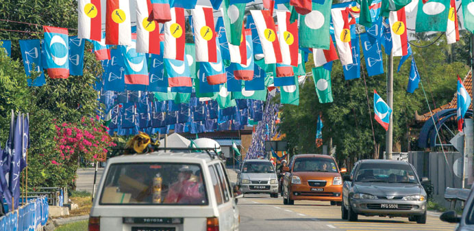 Motorists move under political partiesu2019 flags that hang across the road prior to the 13th Malaysian general elections in Bukit Mertajam, Penang.