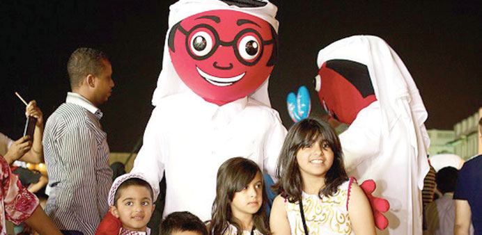    The Alrabaa with a group of children. Right: The Alrabaa with visitors at Souq Waqif.
