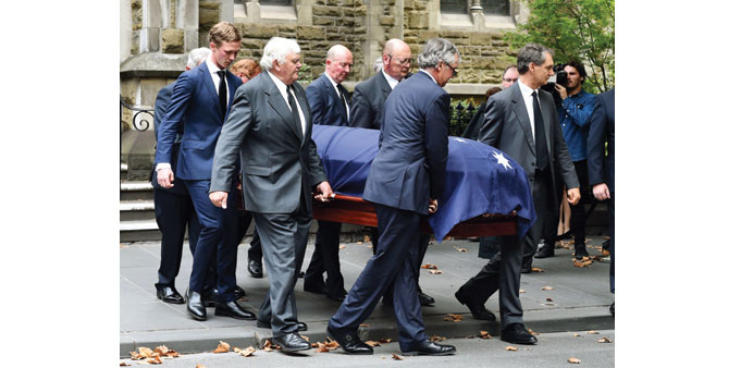 The coffin of former Australian prime minister Malcolm Fraser is carried from the church in Melbourne.