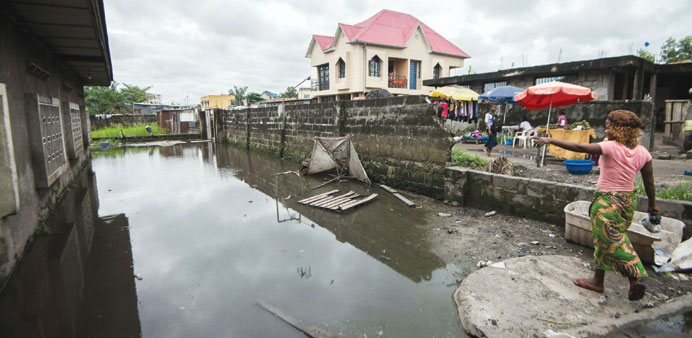 A flooded back alley in Kinshasa