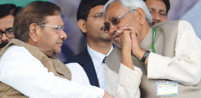 Bihar Chief Minister Nitish Kumar and JD(U) chief Sharad Yadav discuss a point during a party rally at the Gandhi Maidan in Patna yesterday.