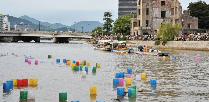 Paper lanterns float on the Motoyasu River in front of the Atomic Bomb Dome on the 69th anniversary of the atomic bombing in Hiroshima yesterday.