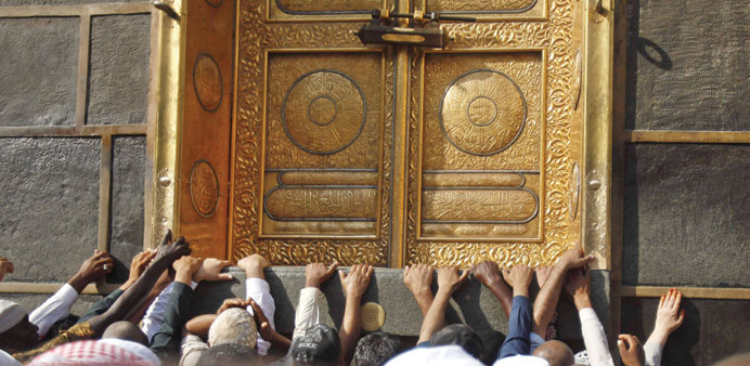 Muslim pilgrims gather around the door of the Kaaba at the Grand Mosque in the holy city of Makkah.