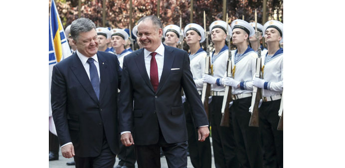 Ukraineu2019s President Petro Poroshenko (left) and his Slovakian counterpart Andrej Kiska chat as they inspect an honour guard during a welcoming ceremon