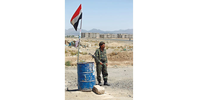 A soldier keeps watch at a checkpoint on the outskirts of Sanaa yesterday.