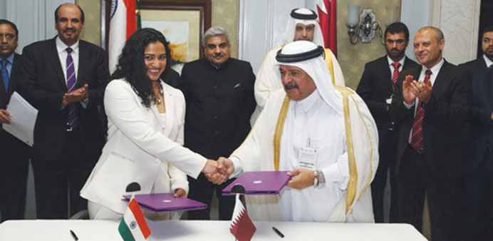 HE Sheikh Faisal bin Qassim after signing the agreement with Amruda Nair.