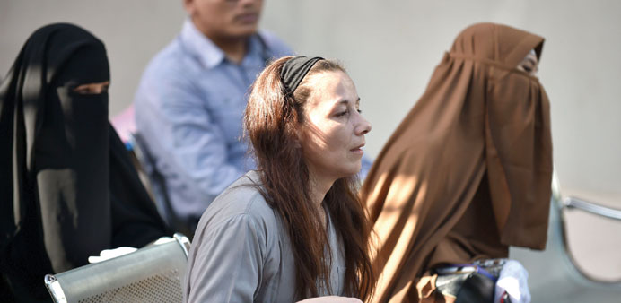 Sabine Atlaoui (centre), wife of French death row prisoner Serge Atlaoui, waits for a boat to visit her husband in Nusakambangan prison island located