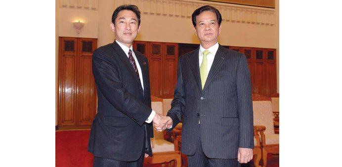 Japanu2019s Foreign Minister Kishida Fumio, left, shaking hands with Vietnamese Prime Minister Nguyen Tan Dung at the Government Office in Hanoi yesterday