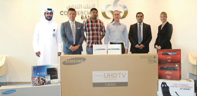 Commercial Bank officials with winners of the  promotion.