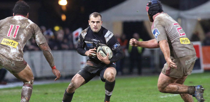 Briveu2019s fly-half Romain Sola (C) runs with the ball during the French Top 14 rugby union match Brive vs Stade Francais at the Amedee-Domenech stadium 
