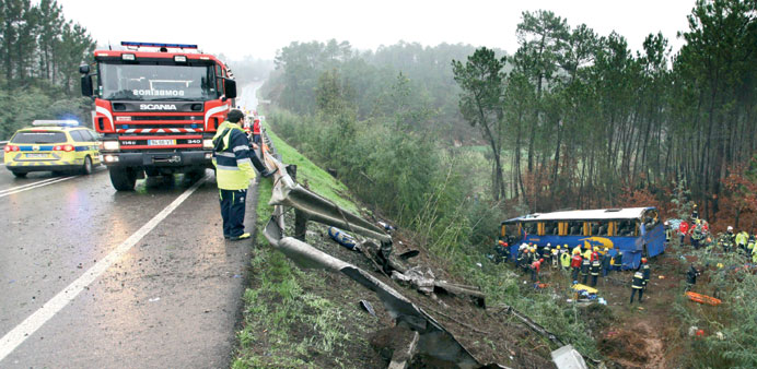 Firefighters work next to the bus that fell in a ravine in Serta district of Castelo Branco, central Portugal.