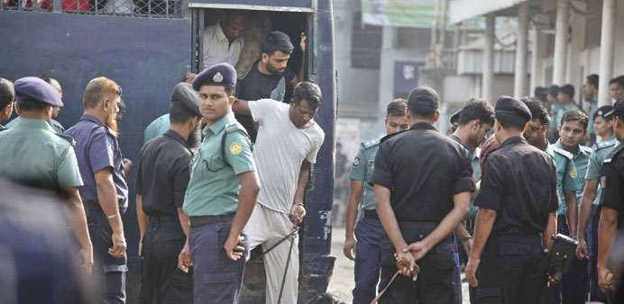 The accused in the case arrive at court prior to the verdict at the Alia Madrasa playground, next to the Dhaka Central Jail.