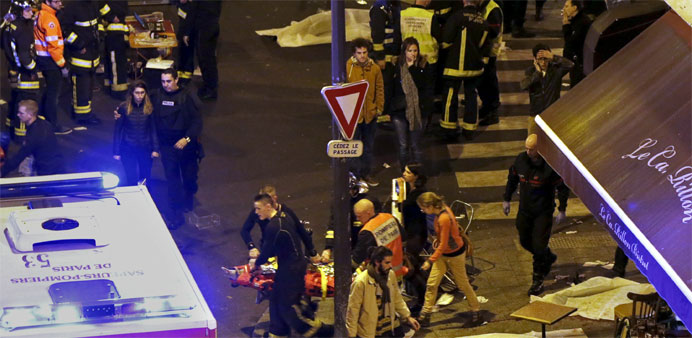 General view of the scene with rescue service personnel working outside a restaurant following shooting incidents in Paris