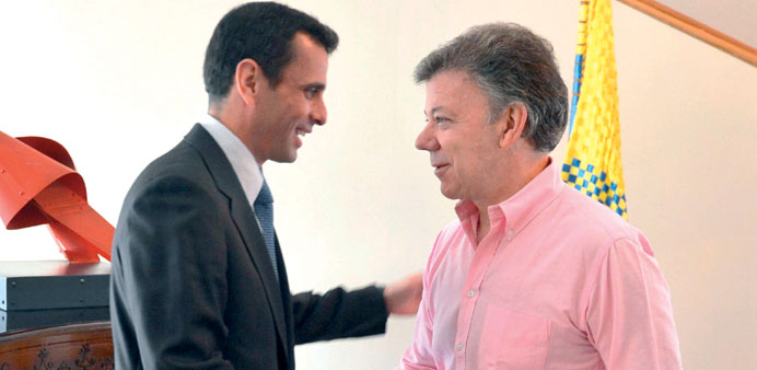 A handout picture provided by the Colombian Presidency shows Santos (right), shaking hands with Capriles during a meeting at Narino Palace on Wednesda