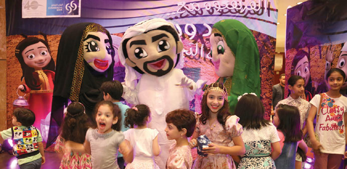 Qatari (twin) cartoon characters u201cJoud wa Soudu201d entertain the crowd.