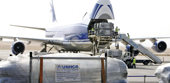 Workers unload humanitarian aid from the United Nations at the airport in Arbil yesterday.
