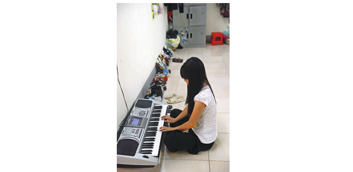 Hu2019mong ethnic teenager May Na (name changed) playing a keyboard in her bedroom at a government-run centre for trafficked women in the northern city of