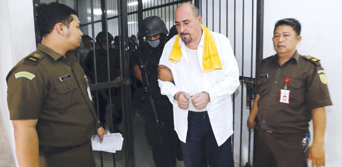 Death row inmate Serge Atlaoui of France is escorted by police as he leaves his cell at Tangerang district court.