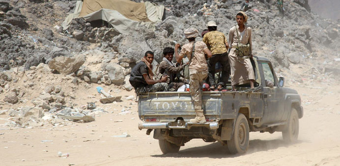Armed Yemeni tribesmen from the Popular Resistance Committees, supporting forces loyal to President Abd-Rabbu Mansour Hadi, sit in the back of a vehic