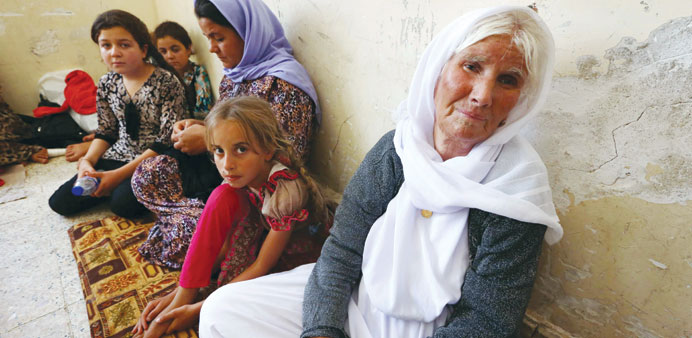 A Yazidi family that fled the violence in Sinjar sit at a school where they are taking shelter in the city of Dohuk in Iraqu2019s autonomous Kurdistan reg