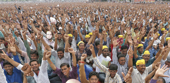 Members of the Patel community raise their arms during a protest rally in Ahmedabad yesterday.