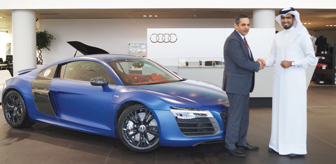 Mohamed al-Kuwari and Mohamed el-Talkhawi stand next to the Audi R8 V10 Plus.