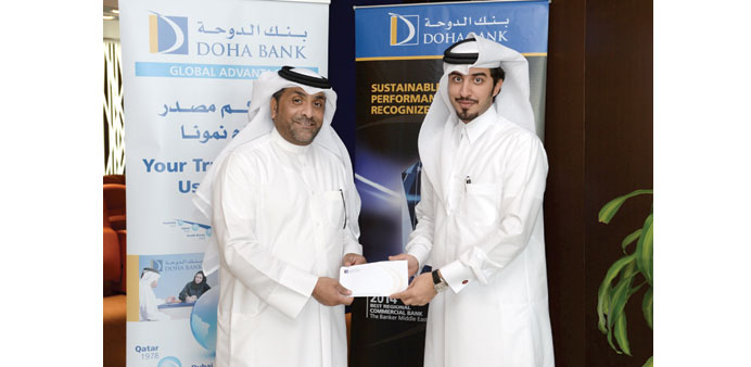Doha Banku2019s cheque worth QR2mn is donated to Qatar Red Crescent.