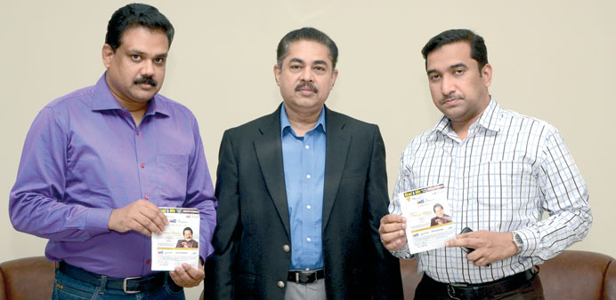 Abulkader and Nizar hold two of the winning coupons as John looks on.