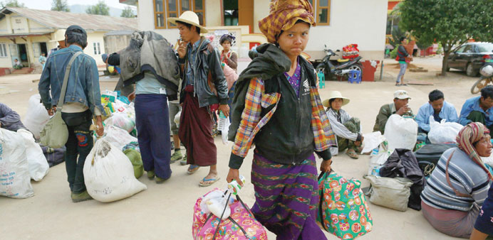 People fleeing from Laukkai, the capital of Kokang in Shan State, arrive at a monastery functioning as a refugee camp in Lashio yesterday.