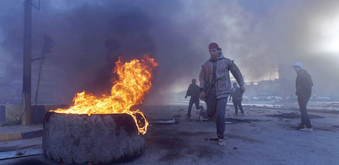 Protesters block a street with burning tyres in Libyau2019s second city of Benghazi yesterday after the killings of two policemen.