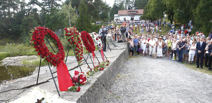 People attend a wreath-laying ceremony on Utoya, during a memorial day for the 69 people killed during Anders Behring Breivik`s shooting rampage in 20