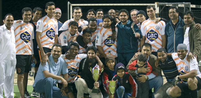 Wanderers and Messaied Industrial City players pose with their trophies at the prize distribution function of the Qatar National Residents League.