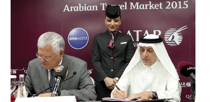 Akbar al-Baker and Driss Benhima signing the joint business agreement at ATM Dubai.