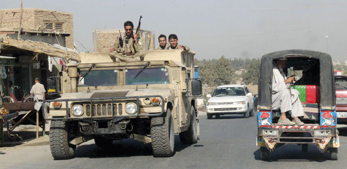 Afghan security forces patrol in an armoured vehicle in Kunduz Province.