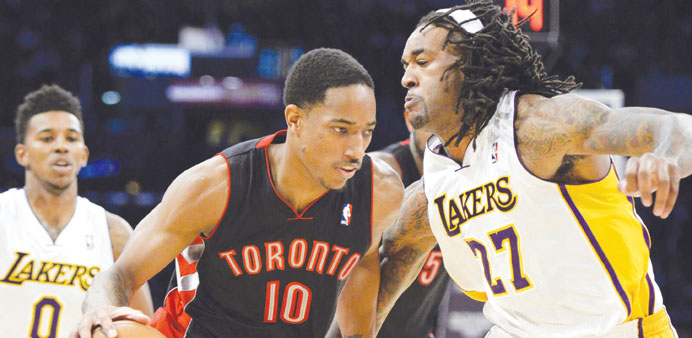 Toronto Raptors shooting guard DeMar DeRozan drives against Los Angeles Lakers center Jordan Hill during the first half at Staples Center on Sunday. (