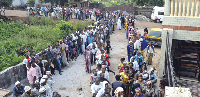 Voters queue at a polling station in Conakry yesterday.