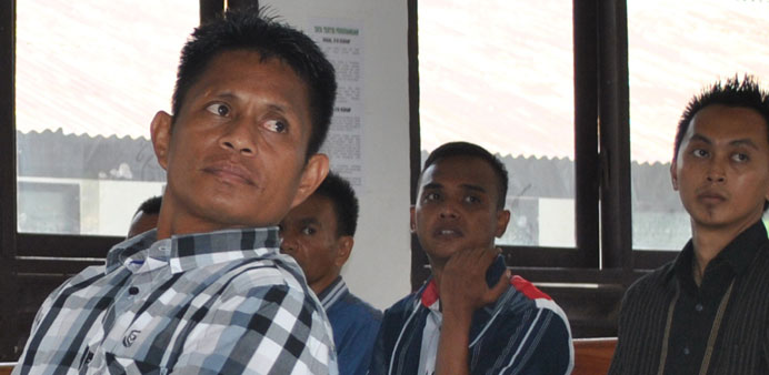 A recent photo shows Indonesian boat captain Yohanis Humiang (left) appear in court with some of his crew members (background) in eastern Indonesiau2019s 