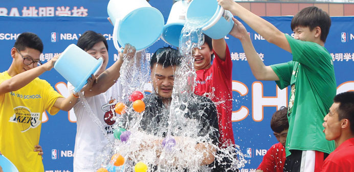 Former NBA star Yao Ming being doused with ice water in an u201cice bucket challengeu201d during a a graduation ceremony for students of his NBA Yao school in