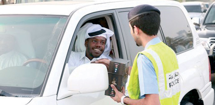  Iftar kits being distributed among motorists on various Doha roads.