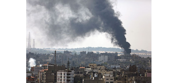 Smoke rising after Israeli tanks shell the Al Shejaeiya neighbourhood in the east of Gaza City yesterday.