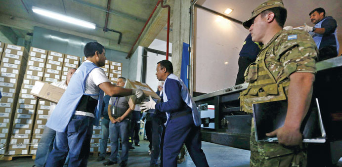 Postal workers carry ballot boxes to a truck in Buenos Aires ahead of todayu2019s presidential election.