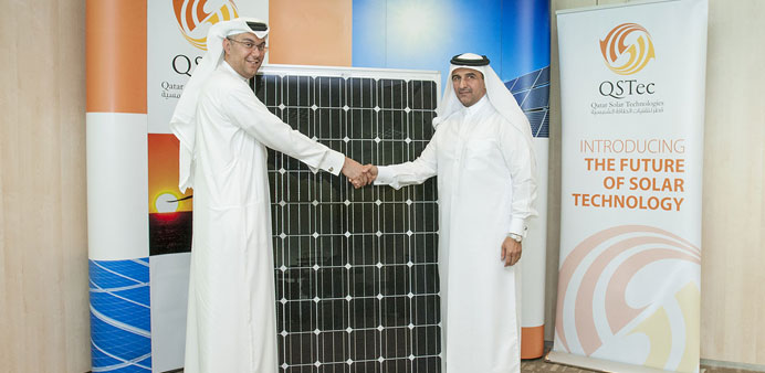 Dr Khalid al-Hajri and Ahmad Abdulla al-Abdulla shaking hands at the solar module handing-over ceremony.