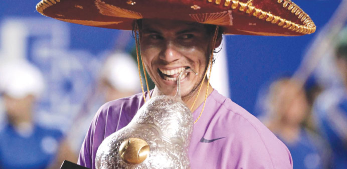 Rafael Nadal of Spain wearing a sombrero, poses with his trophy